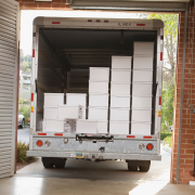 moving truck with white boxes in a garage